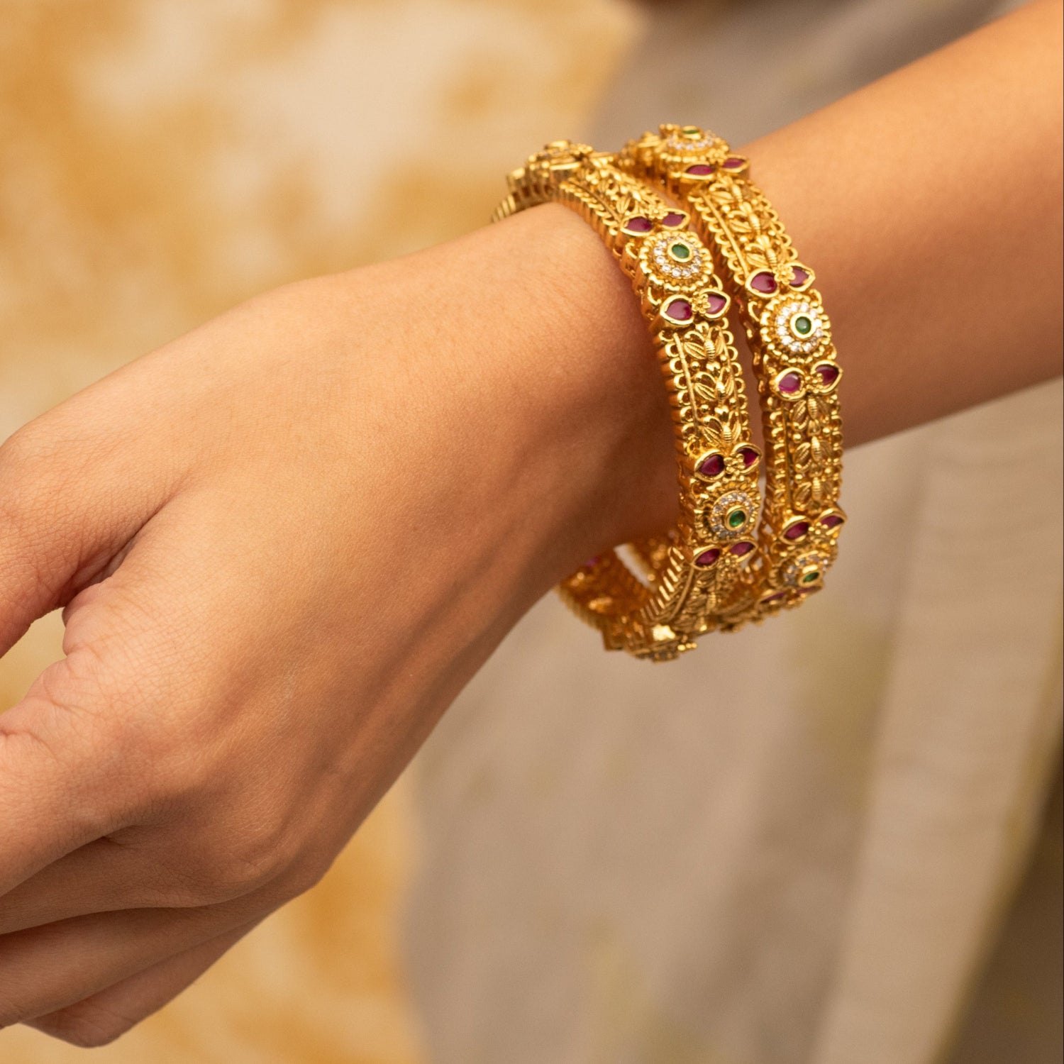 Close-up photo of an antique bangle with multi gemstones.