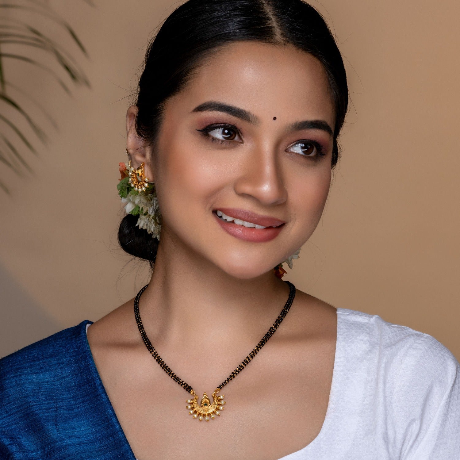 A picture of a necklace, featuring green and black beads necklace with cubic zirconia stones.